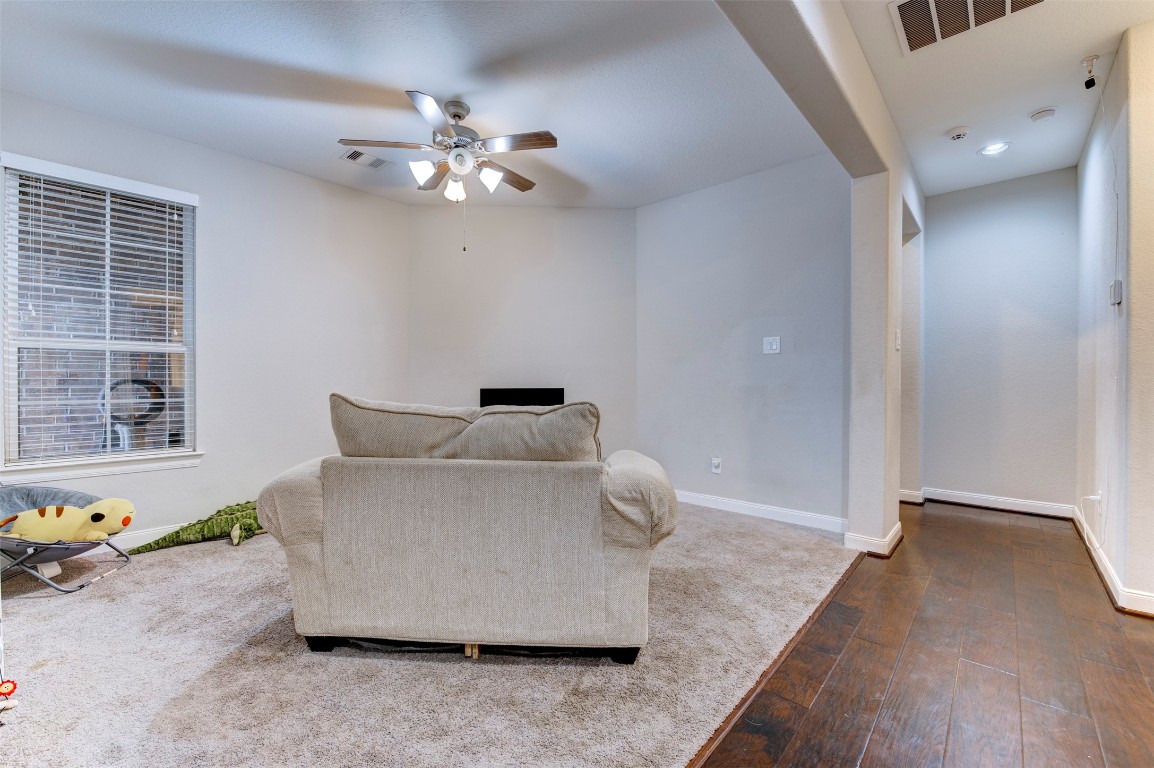 6242 Avon Landing Lane Spring, TX 77379 - Photo 31 of 42 a living room with furniture and a chandelier