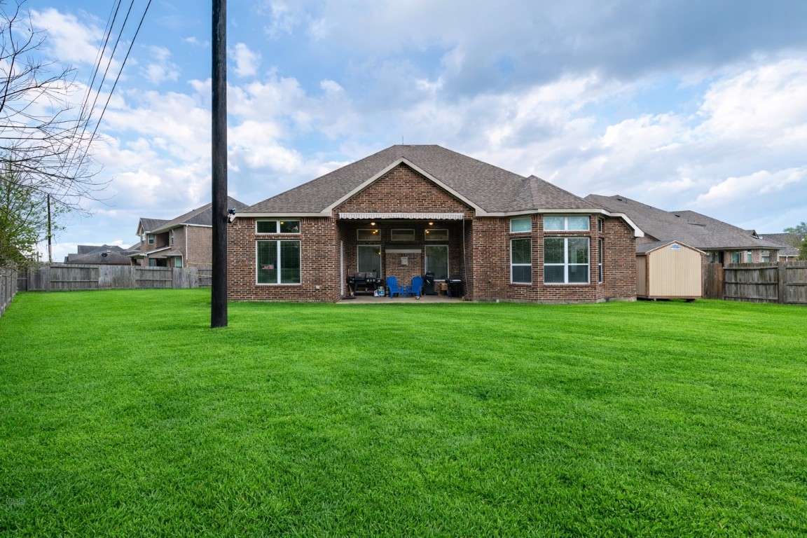 6242 Avon Landing Lane Spring, TX 77379 - Photo 40 of 42 a front view of a house with a yard table and chairs