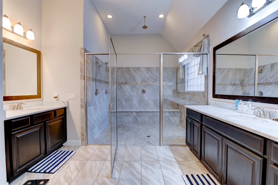 6242 Avon Landing Lane Spring, TX 77379 - Photo 5 of 42 a bathroom with a double vanity sink a large mirror and shower