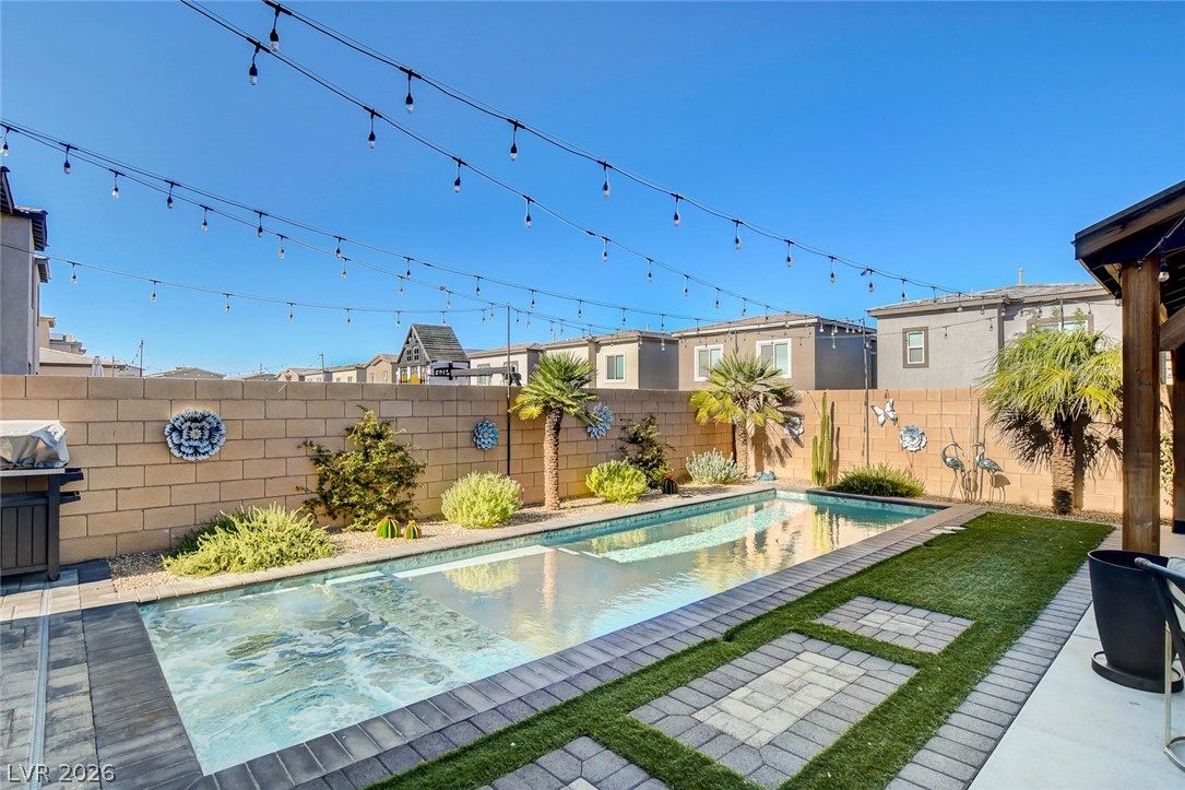 9688 Rankin Rdg Court Las Vegas, NV 89178 - Photo 52 of 53 An inviting backyard oasis offers a sparkling pool with a surrounding patio and lush, low-maintenance landscaping.