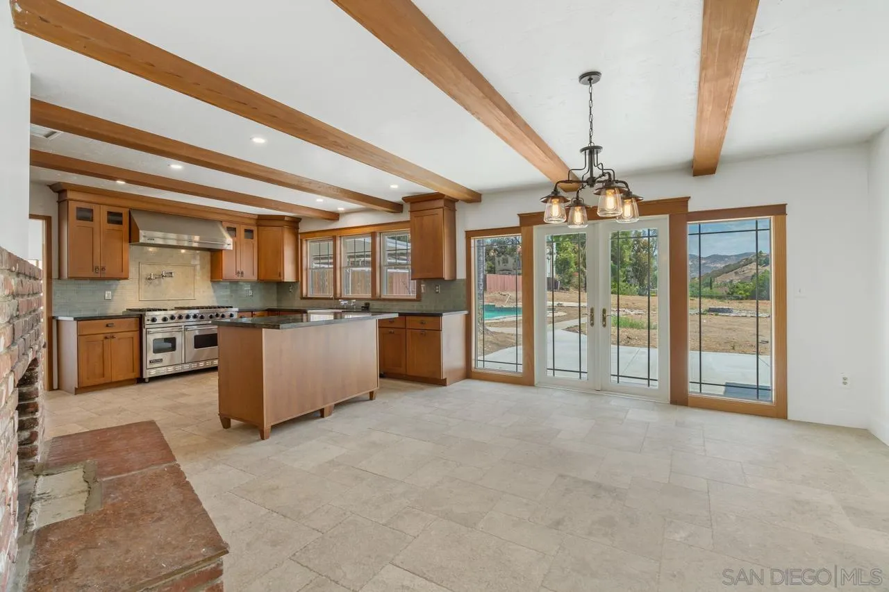 11823 Rocoso Road Lakeside, CA 92040 - Photo 11 of 48 a open kitchen with stainless steel appliances granite countertop a stove and cabinets