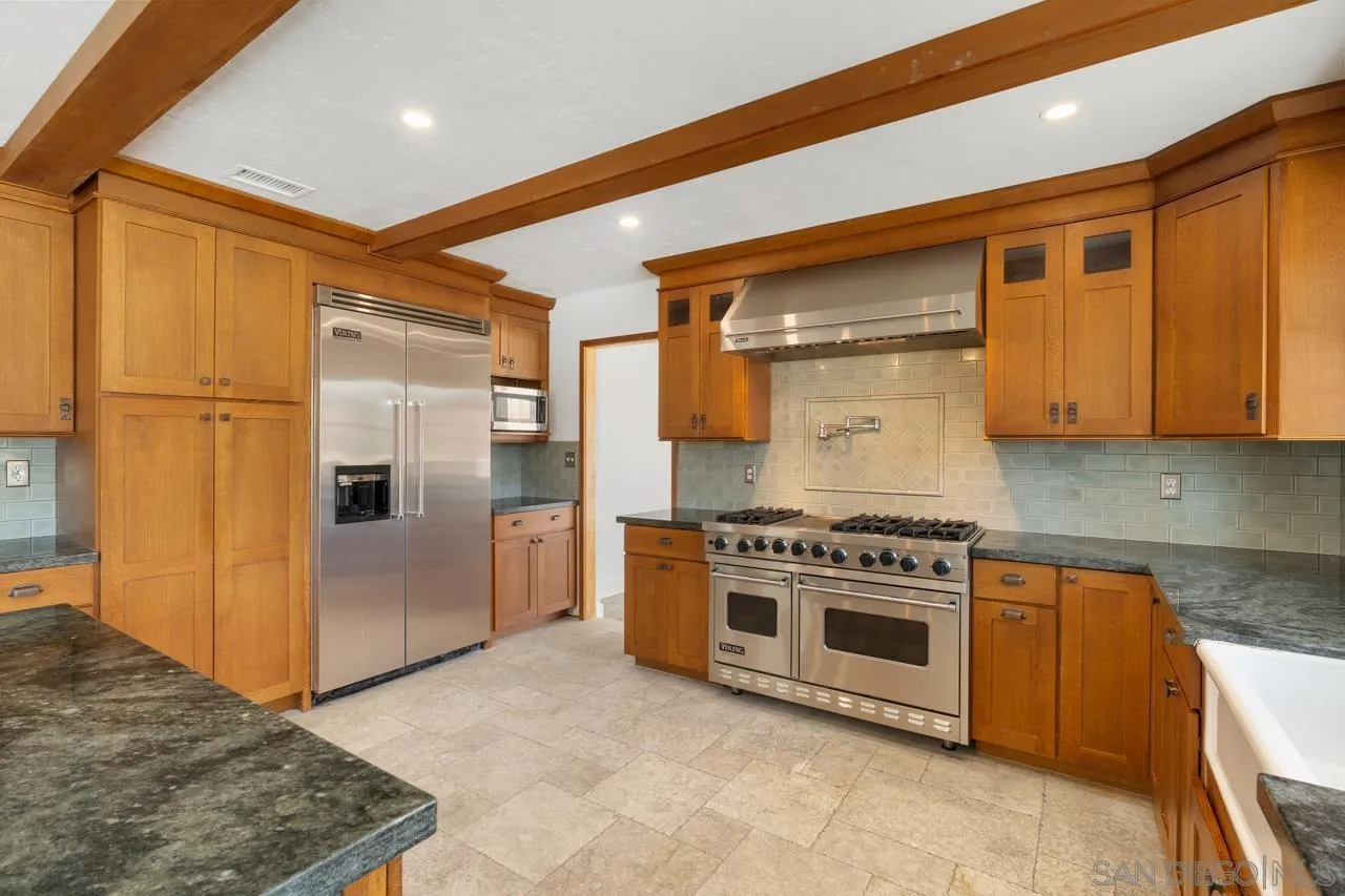 11823 Rocoso Road Lakeside, CA 92040 - Photo 17 of 48 a kitchen with stainless steel appliances granite countertop a stove a sink and a refrigerator