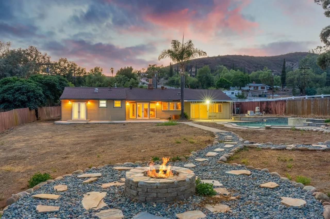 11823 Rocoso Road Lakeside, CA 92040 - Photo 2 of 48 a backyard of a house with table chairs and a fire pit