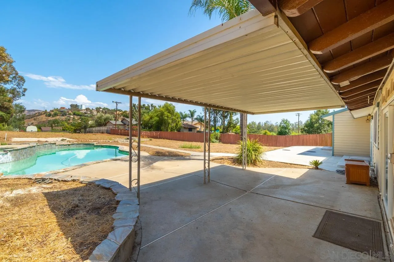 11823 Rocoso Road Lakeside, CA 92040 - Photo 30 of 48 a view of a backyard with table and chairs under an umbrella