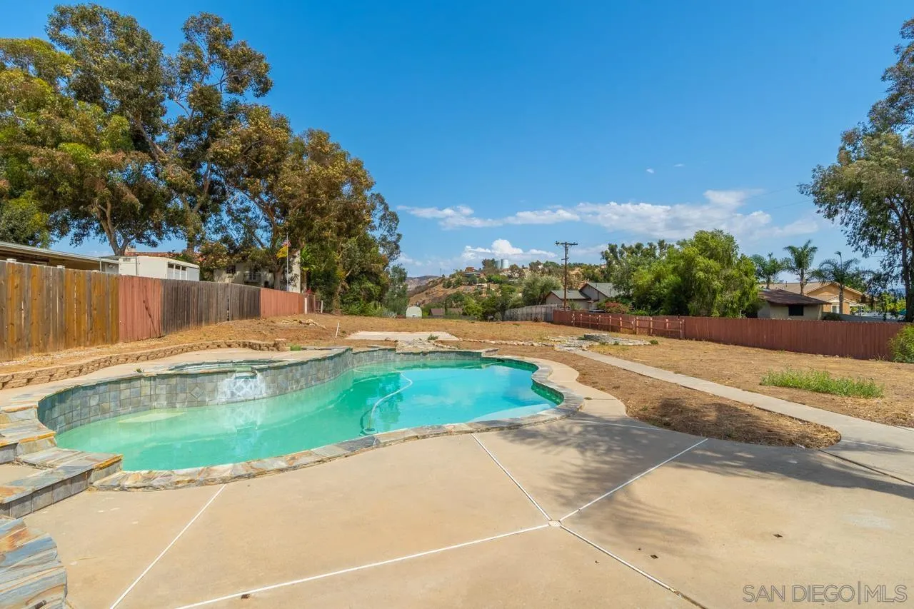 11823 Rocoso Road Lakeside, CA 92040 - Photo 32 of 48 a view of a swimming pool with a yard