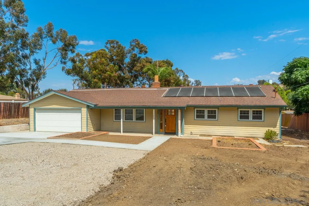 11823 Rocoso Road Lakeside, CA 92040 - Photo 43 of 48 a front view of a house with a yard and potted plants