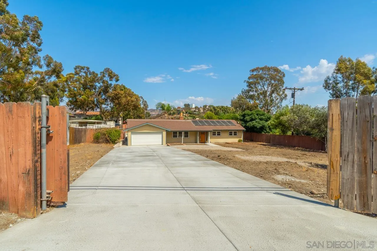 11823 Rocoso Road Lakeside, CA 92040 - Photo 46 of 48 a front view of a house with a yard and garage
