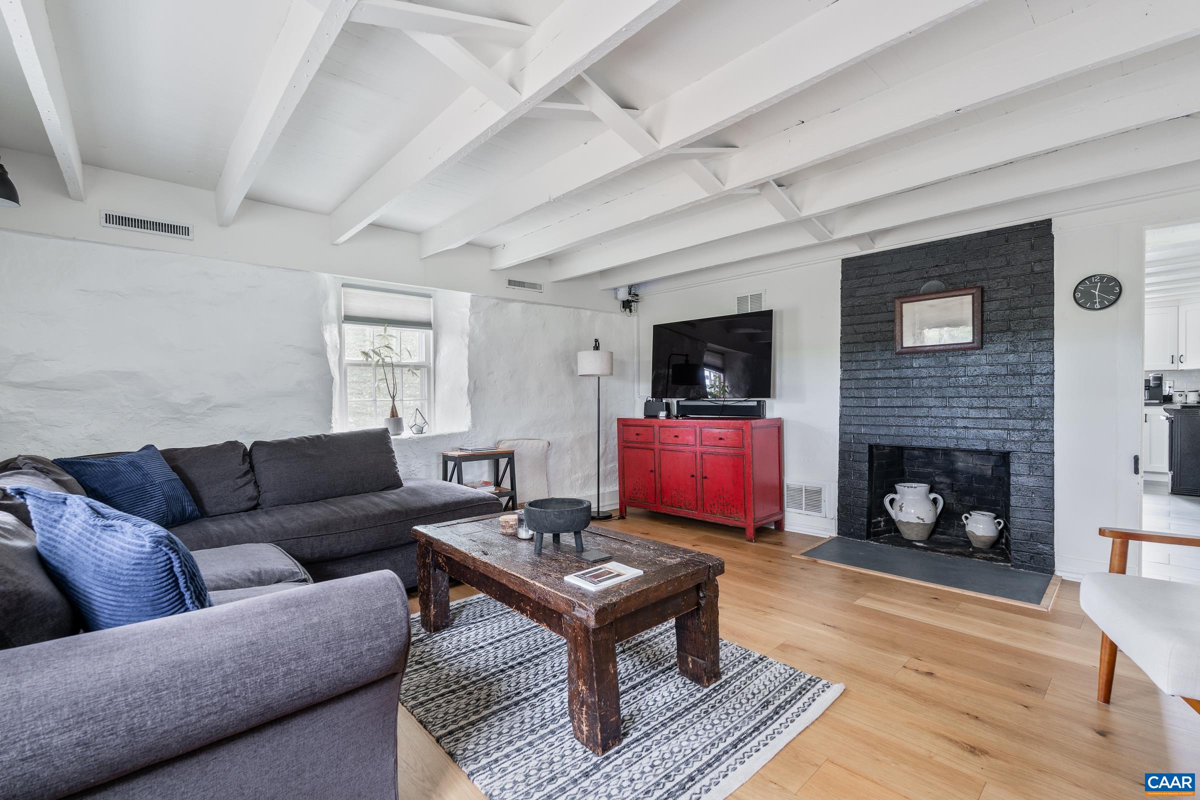 1859 Rivanna Farm Charlottesville, VA 22911 - Photo 33 of 45 The living room features a wood-burning fireplace that serves as the heart of the home.