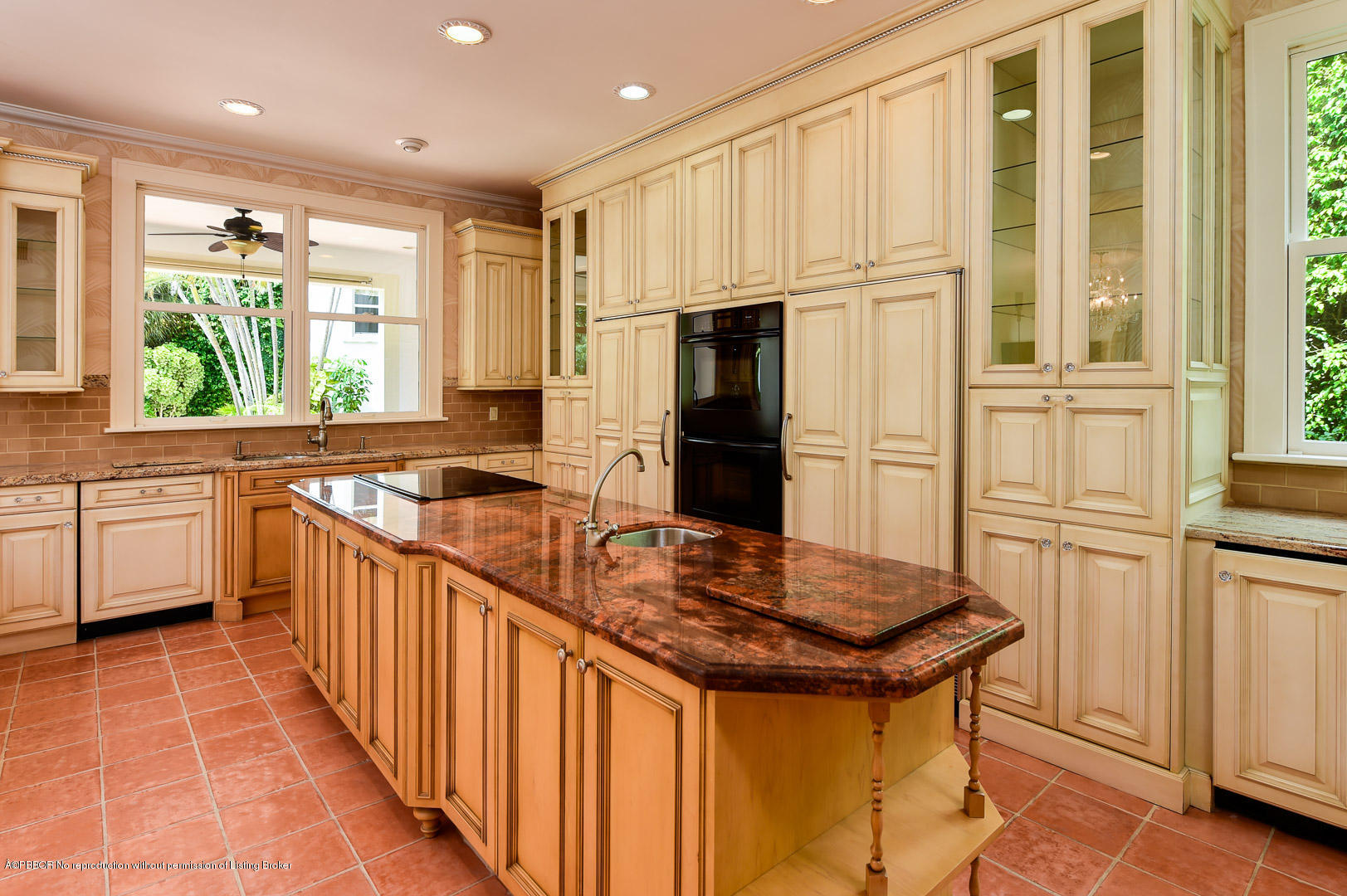 142 South County Road Palm Beach, FL 33480 - Photo 4 of 12 a kitchen with stainless steel appliances granite countertop a refrigerator a sink dishwasher and white cabinets with wooden floor