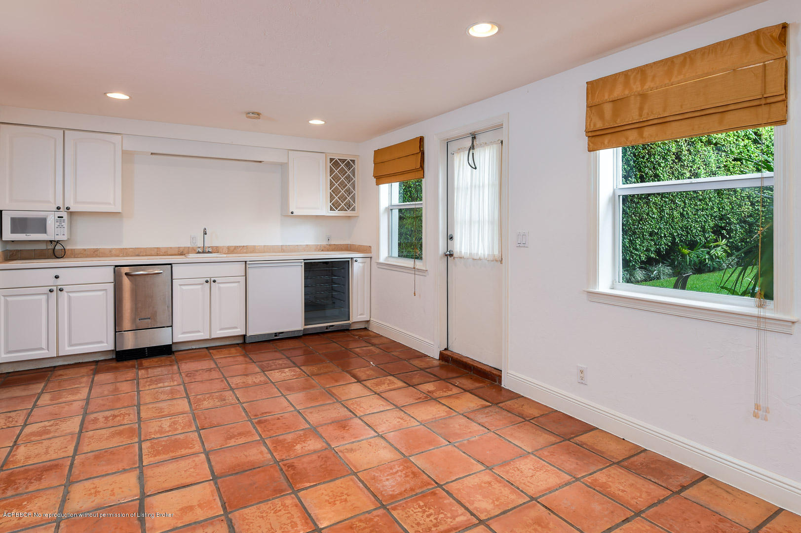 142 South County Road Palm Beach, FL 33480 - Photo 9 of 12 a large white kitchen with a sink window and cabinets