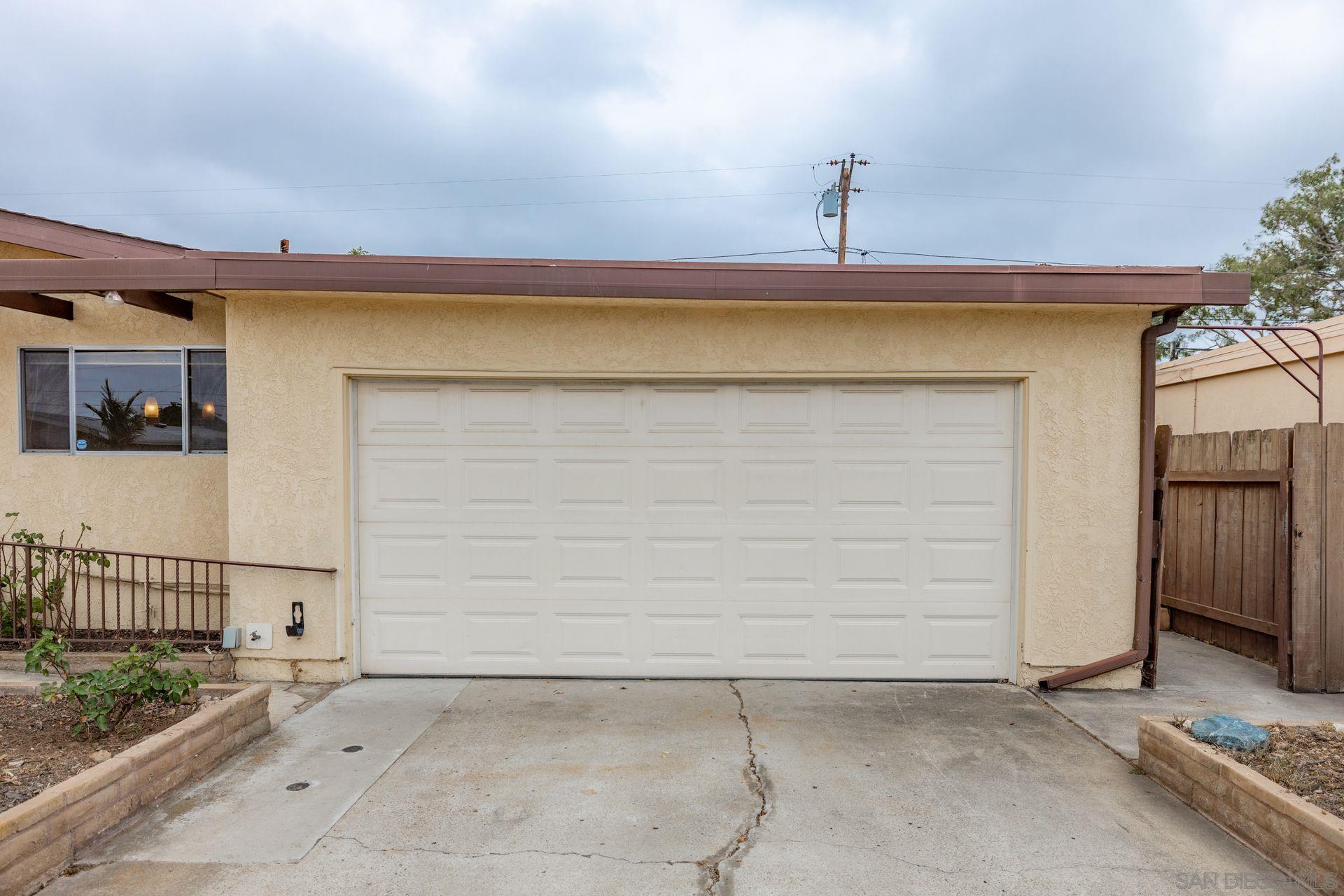 5004 Ensign Street San Diego, CA 92117 - Photo 1 of 34 a view of a garage with wooden walls