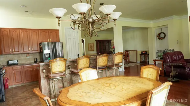 a dining room with furniture and chandelier