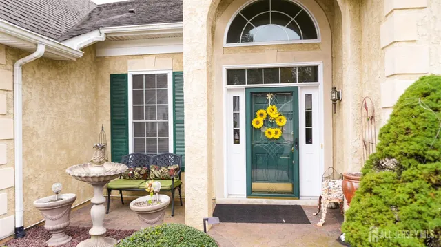 a view of a front door of the house with outdoor seating