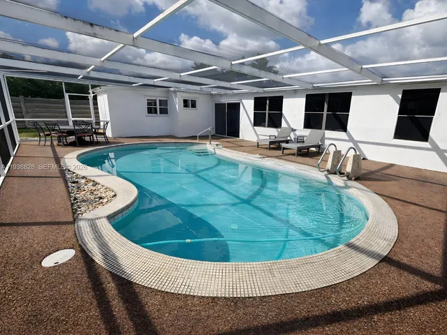 a view of a swimming pool with seating area