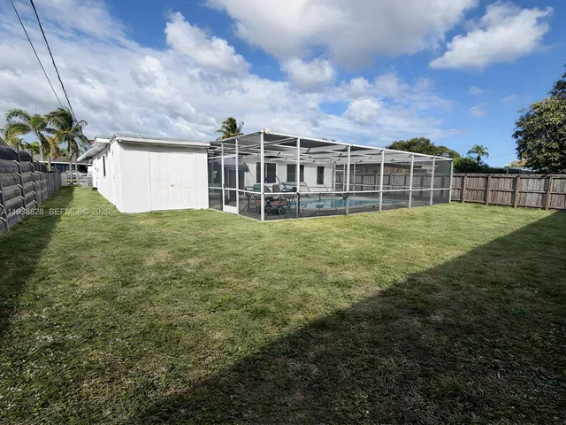a view of a house with a yard and sitting area