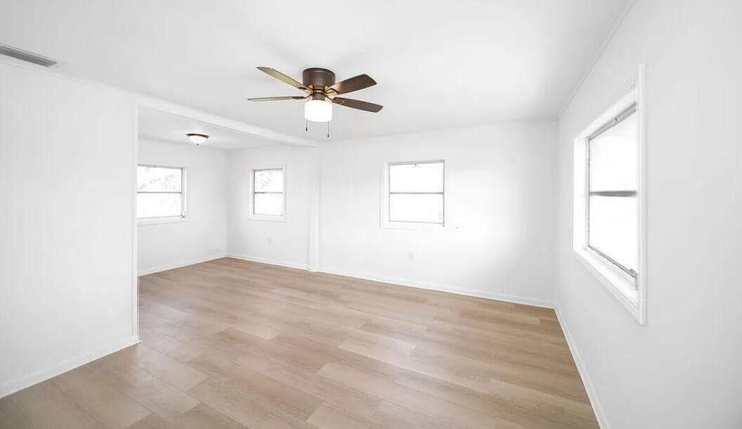 1520 Hunter Road Okeechobee, FL 34974 - Photo 13 of 20 wooden floor in an empty room with a window