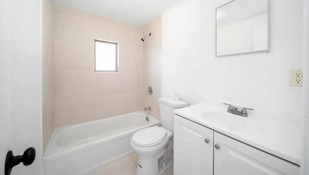 1520 Hunter Road Okeechobee, FL 34974 - Photo 16 of 20 a white toilet sitting next to a bath tub