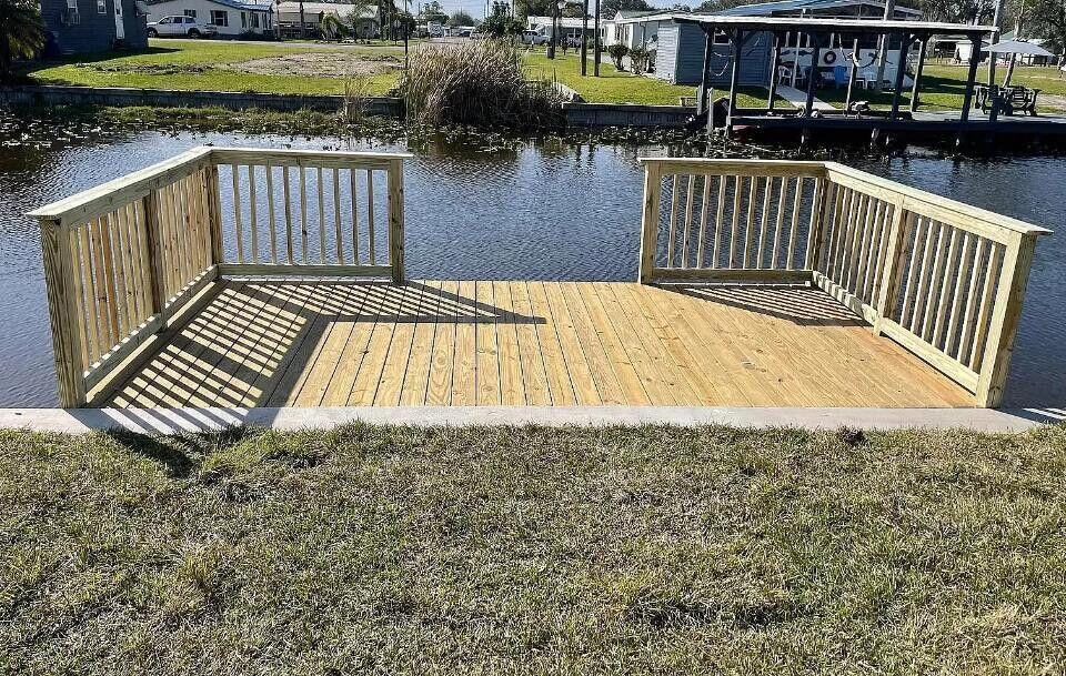 1520 Hunter Road Okeechobee, FL 34974 - Photo 20 of 20 a view of a wooden deck and lake