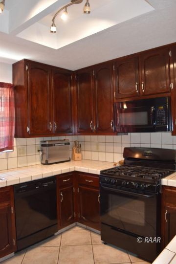 321 East Wilson Avenue Ridgecrest, CA 93555 - Photo 9 of 16 a kitchen with a sink and a stove