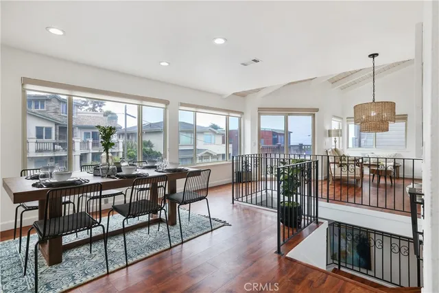 a kitchen with a table a refrigerator a microwave a dining table and chairs