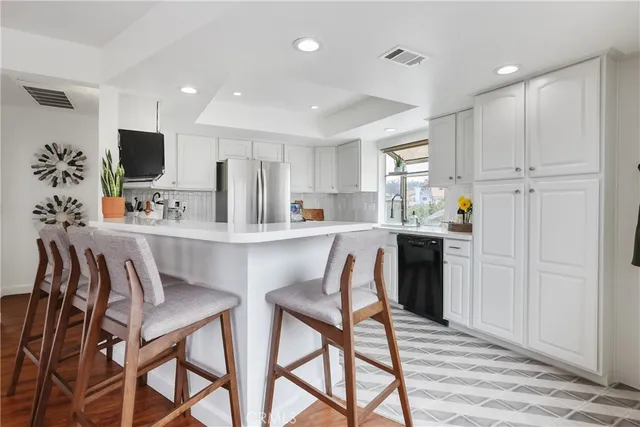 a kitchen with stainless steel appliances a sink a stove and cabinets
