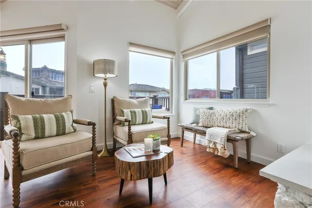 a bedroom with a bed couches and wooden floor