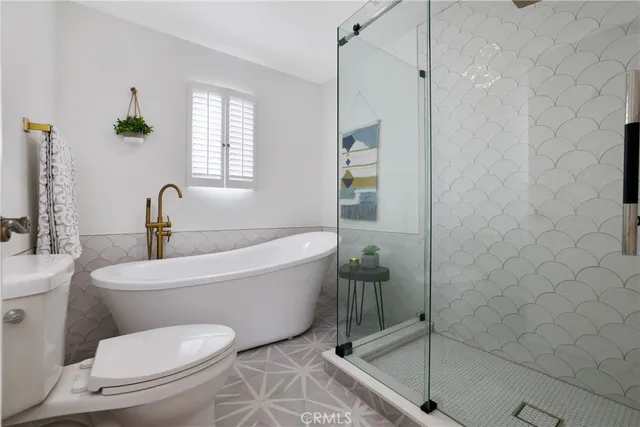 a bedroom with two beds and a large window