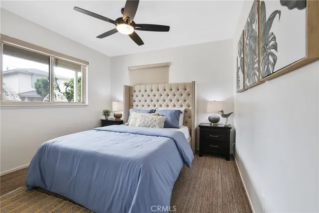 an aerial view of ocean and residential houses with outdoor space