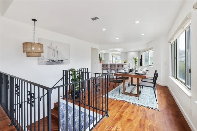 a living room with furniture a window and a potted plant