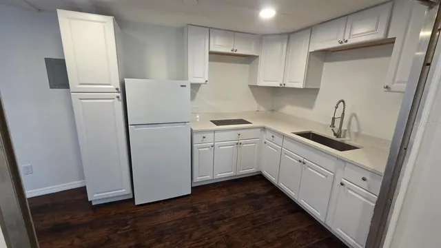 a kitchen with white cabinets and white appliances
