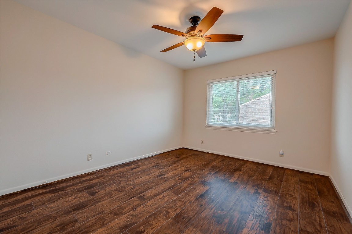 2047 Winrock Boulevard, Unit 61 Houston, TX 77057 - Photo 23 of 50 an empty room with wooden floor and windows
