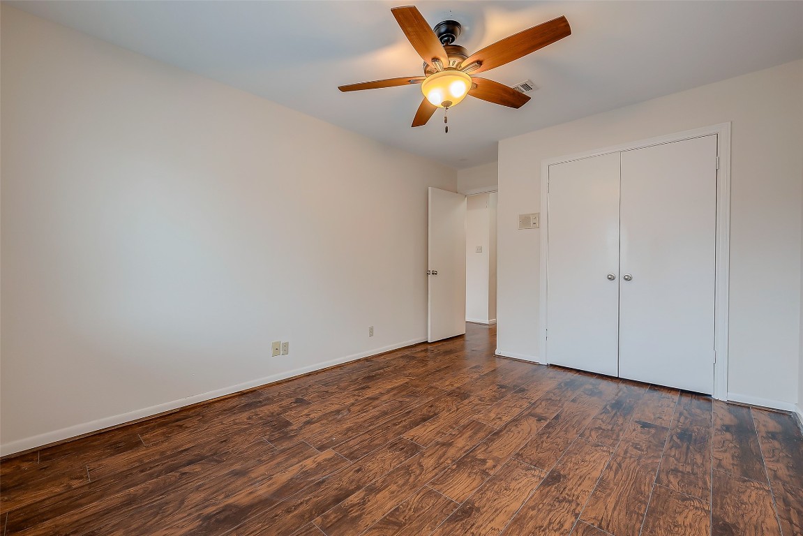 2047 Winrock Boulevard, Unit 61 Houston, TX 77057 - Photo 24 of 50 an empty room with wooden floor and a ceiling fan
