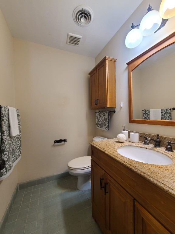 2047 Winrock Boulevard, Unit 61 Houston, TX 77057 - Photo 34 of 50 a bathroom with a granite countertop sink a toilet and a mirror