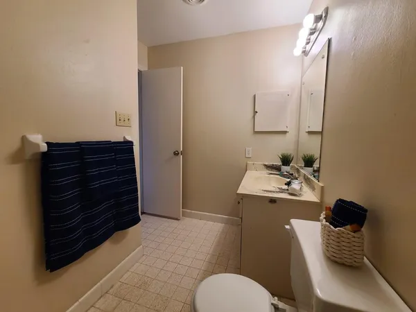 a bathroom with a sink toilet and mirror