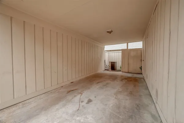 a view of a livingroom with an empty space and a window