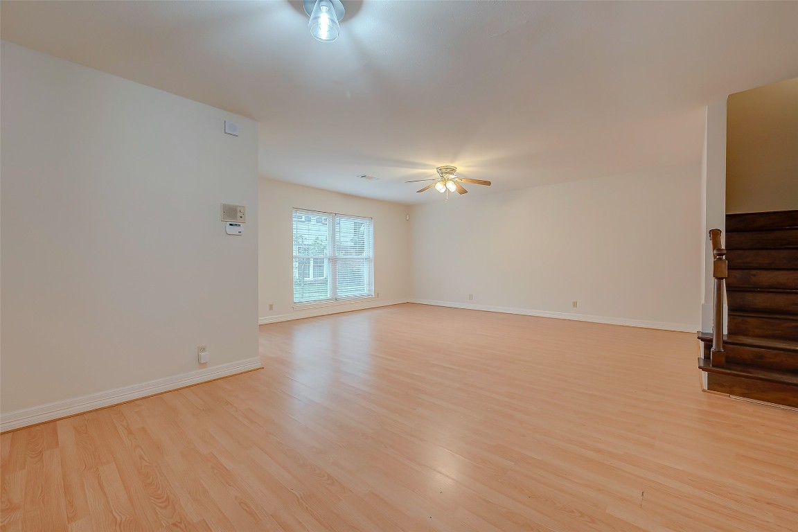 2047 Winrock Boulevard, Unit 61 Houston, TX 77057 - Photo 7 of 50 wooden floor in an empty room with a window