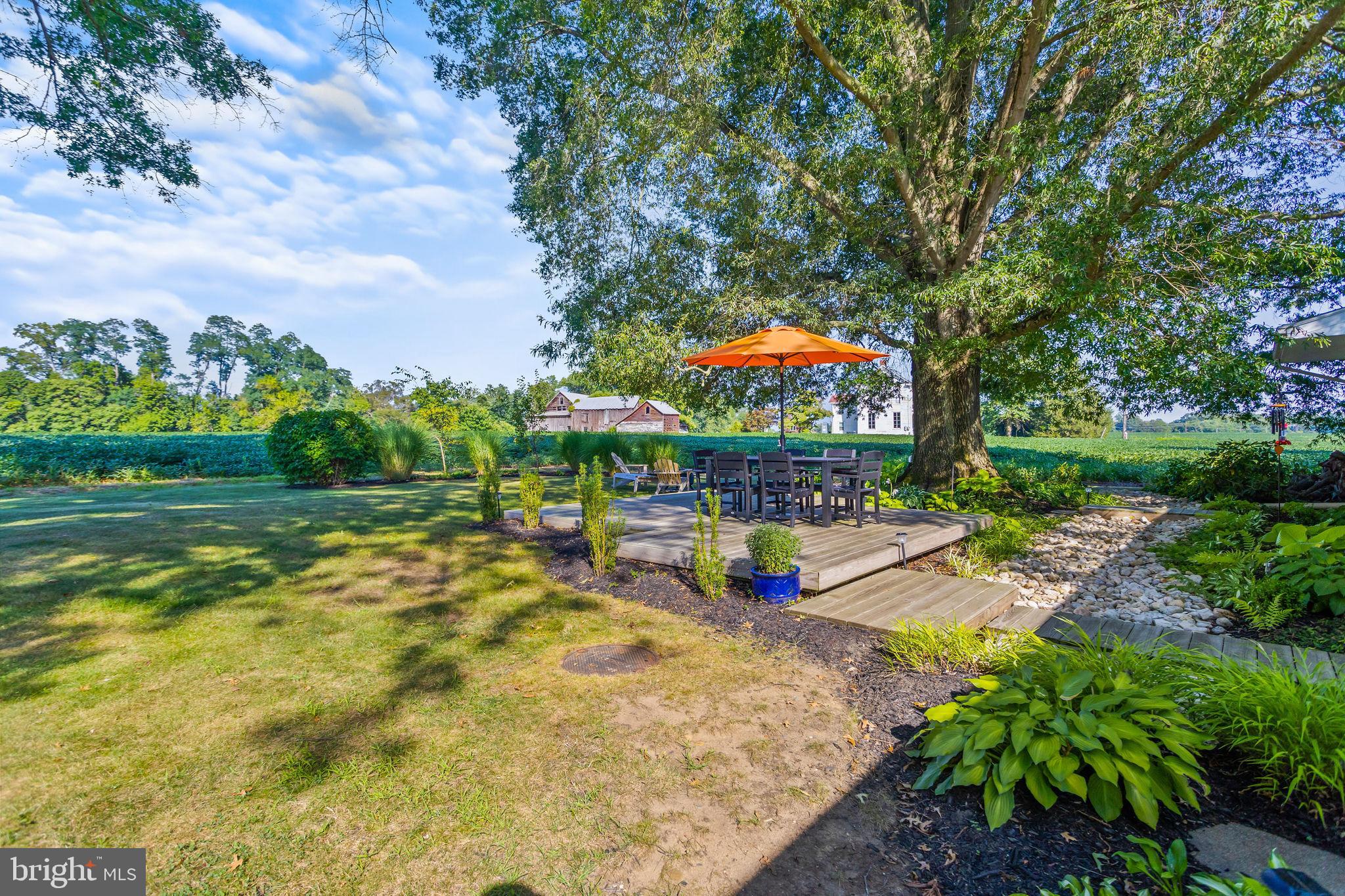 415 Ellisdale Road Chesterfield, NJ 08515 - Photo 40 of 47 a view of a swimming pool with a table and chairs under an umbrella