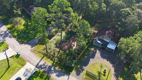 an aerial view of a house with a yard and garden