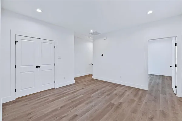 a view of an empty room with wooden floor