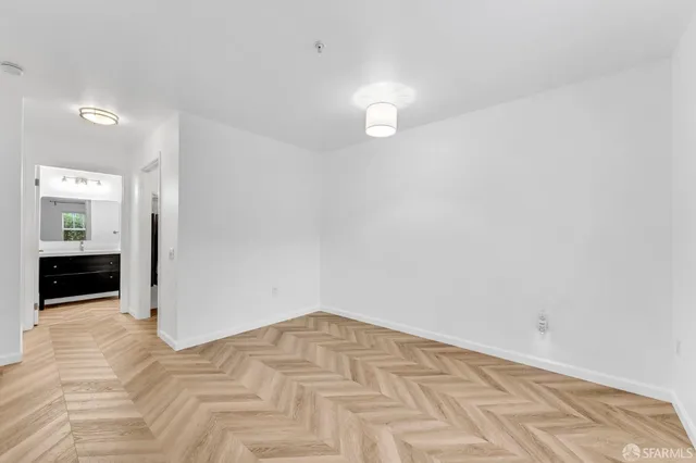 a view of empty room with wooden floor
