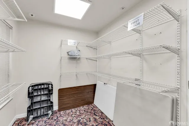 a view of a hallway with closet and wooden floor