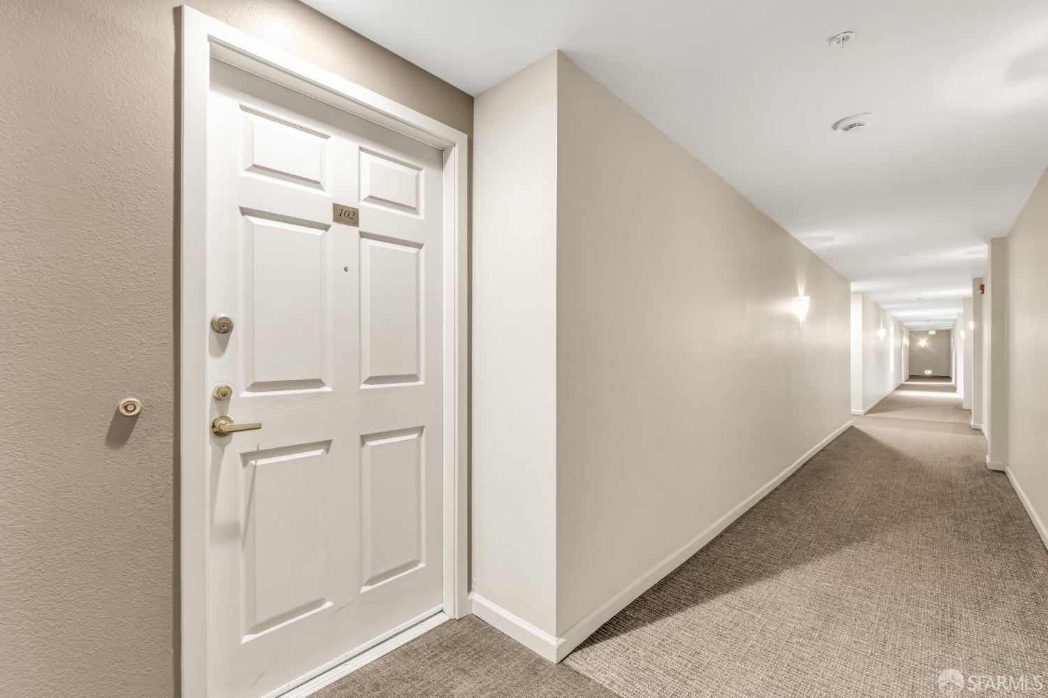 555 10th Street, Unit 102 Oakland, CA 94607 - Photo 36 of 38 a view of a hallway with closet and wooden floor