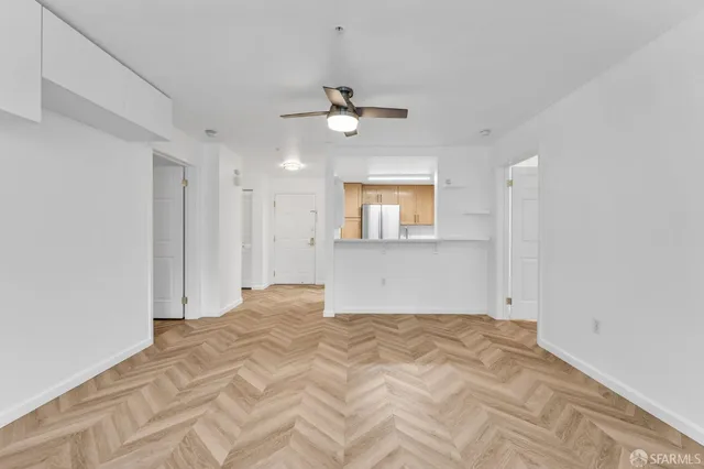 a view of empty room with wooden floor