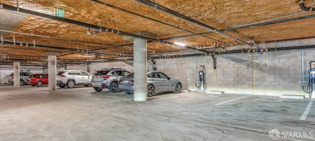 a view of parking garage with cars