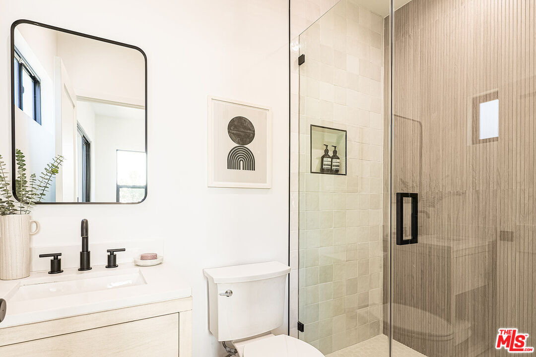 5117 Coringa Drive Los Angeles, CA 90042 - Photo 19 of 27 a bathroom with a sink a toilet and shower