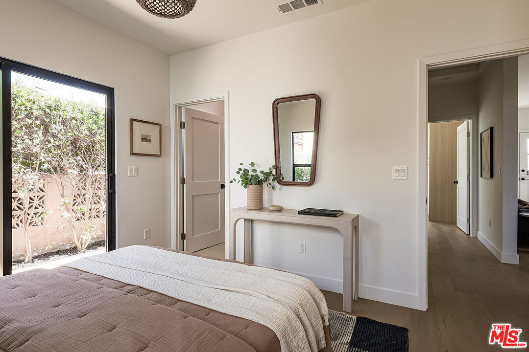 5117 Coringa Drive Los Angeles, CA 90042 - Photo 21 of 27 a bedroom with a bed and a mirror