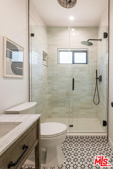 5117 Coringa Drive Los Angeles, CA 90042 - Photo 23 of 27 a bathroom with a shower a toilet and a sink