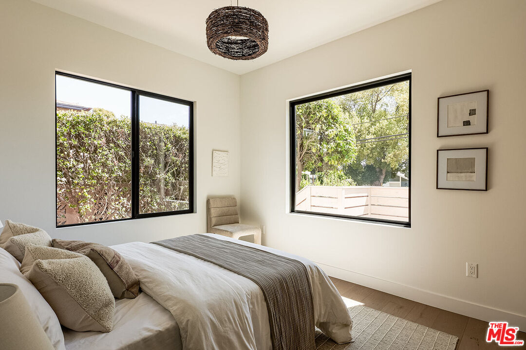 5117 Coringa Drive Los Angeles, CA 90042 - Photo 24 of 27 a bedroom with a large bed and a large window