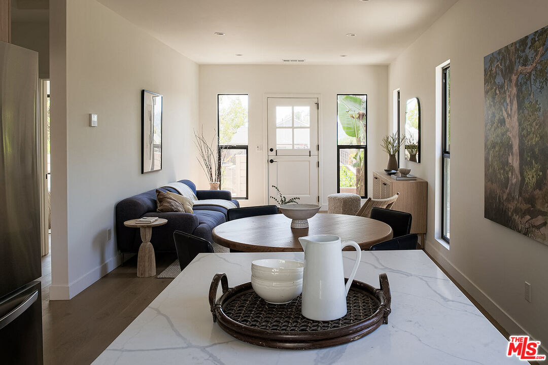 5117 Coringa Drive Los Angeles, CA 90042 - Photo 10 of 27 a dining room with furniture and a chandelier