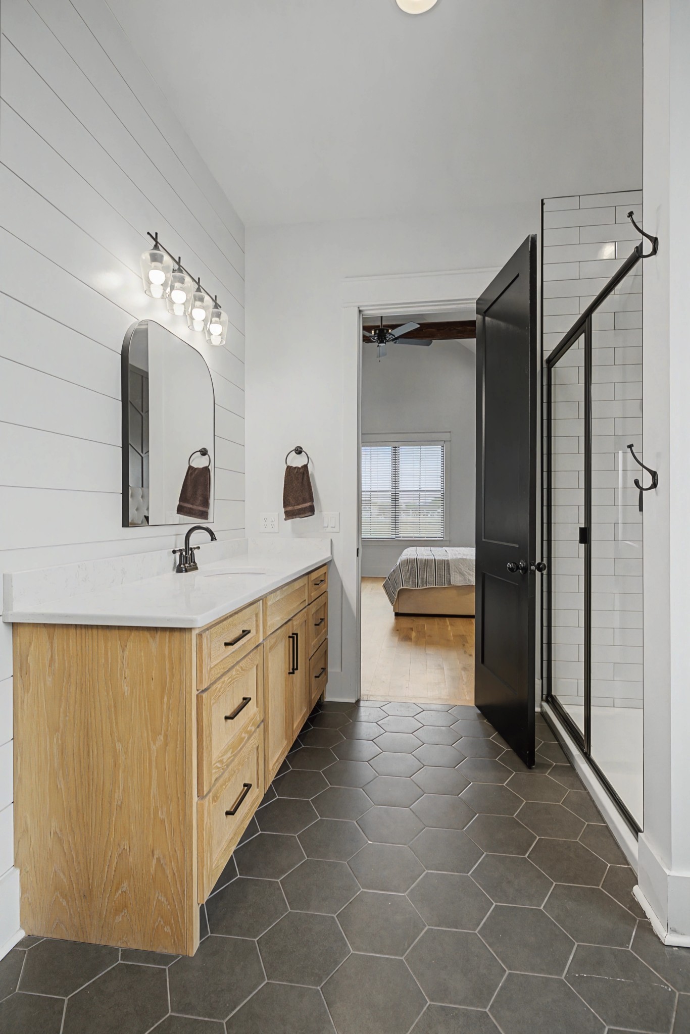 110 Squire Jones Road Bell Buckle, TN 37020 - Photo 31 of 50 a bathroom with a double vanity sink a toilet and a shower